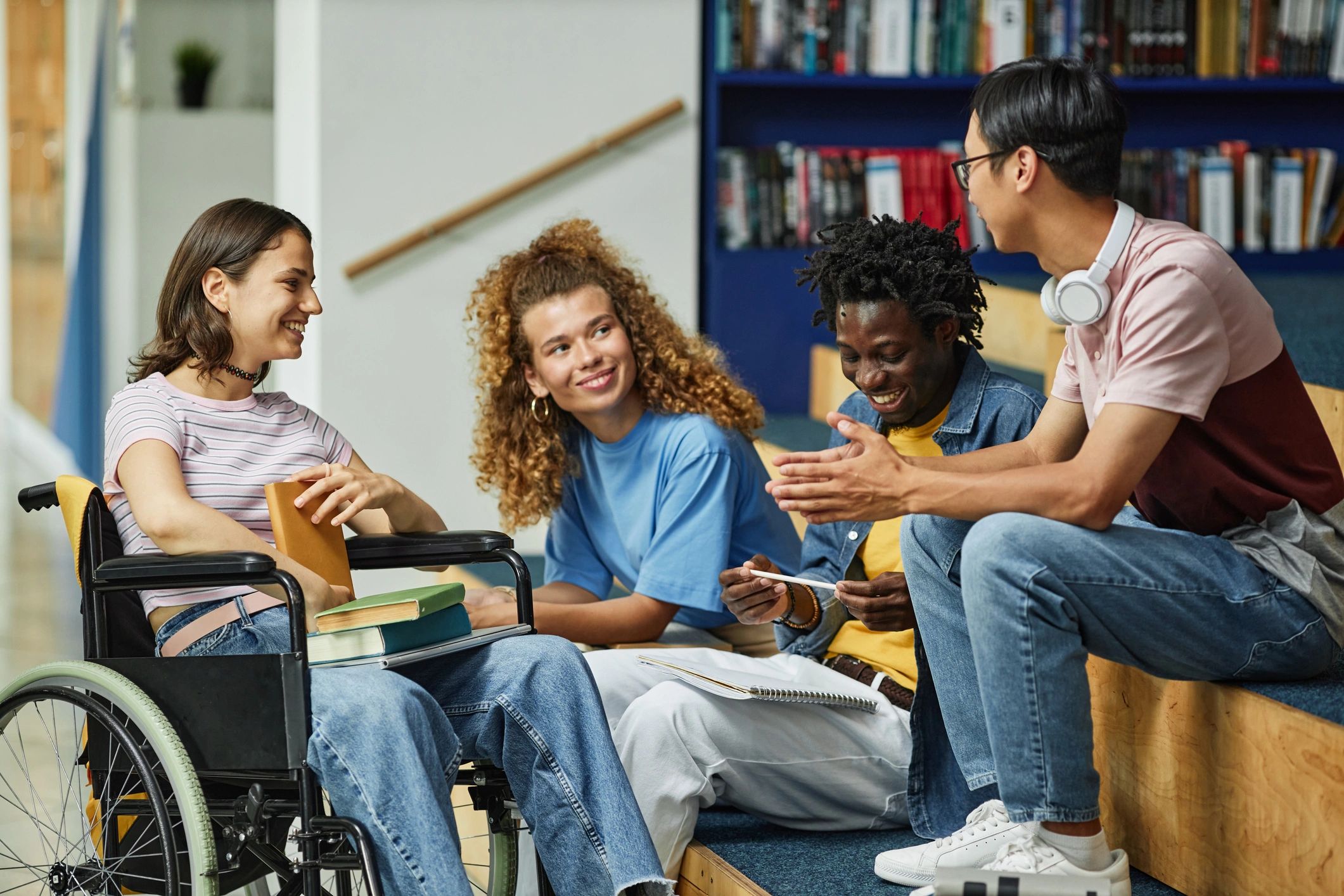 Students chatting together in a college library